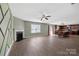 Open-concept living room features a fireplace, decorative wall, and wood floors at 5008 Social Cir, Fort Mill, SC 29707