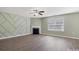 Bright living room features wood floors, a fireplace, unique accent wall, and an abundance of natural light at 5008 Social Cir, Fort Mill, SC 29707