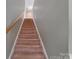 Carpeted staircase with wooden handrail leading to the upper level of the home at 5008 Social Cir, Fort Mill, SC 29707