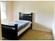 A simple bedroom with a bed and neutral decor at 7448 Forney Hill Rd, Denver, NC 28037