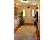 Inviting entryway with hardwood floors, decorative rug, and staircase with wood trim at 7448 Forney Hill Rd, Denver, NC 28037