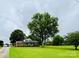 Charming brick home with lush green lawn and mature trees creates a picturesque setting at 7448 Forney Hill Rd, Denver, NC 28037