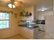 Cozy kitchen nook features a breakfast bar, white cabinetry, and natural light at 7448 Forney Hill Rd, Denver, NC 28037