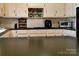 Kitchen with ample counter space, white cabinets, and stylish backsplash at 7448 Forney Hill Rd, Denver, NC 28037