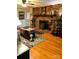 Inviting living room featuring a brick fireplace, hardwood floors, comfortable seating, and natural light at 7448 Forney Hill Rd, Denver, NC 28037