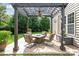 Backyard patio with ceiling fan and comfortable seating around a stone fire pit at 8115 Wilburn Ct, Charlotte, NC 28277