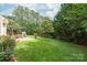 Expansive backyard with pergola-covered patio, storage shed, and mature trees at 8115 Wilburn Ct, Charlotte, NC 28277