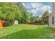 Expansive backyard with a charming shed, manicured lawn, and a pergola-covered patio at 8115 Wilburn Ct, Charlotte, NC 28277
