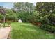 Lush backyard featuring a pergola-covered patio, shed, and beautiful landscaping at 8115 Wilburn Ct, Charlotte, NC 28277
