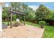 Relax in the lovely backyard featuring a pergola covered patio, shed, and lush landscaping at 8115 Wilburn Ct, Charlotte, NC 28277