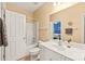 Bathroom with a single sink, tub/shower, and a mirror offering a glimpse into the bedroom at 8115 Wilburn Ct, Charlotte, NC 28277