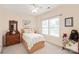 Bedroom with wooden furniture, a teddy bear, and natural light from a large window at 8115 Wilburn Ct, Charlotte, NC 28277