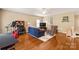 Spacious bonus room with hardwood floors, ceiling fan, and comfortable seating arrangement at 8115 Wilburn Ct, Charlotte, NC 28277