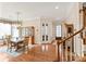 Formal dining room with hardwood floors, chandelier, and wainscoting, adjacent to the staircase at 8115 Wilburn Ct, Charlotte, NC 28277