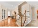 Welcoming entryway with hardwood floors, a grandfather clock, and a staircase with carpeted steps at 8115 Wilburn Ct, Charlotte, NC 28277