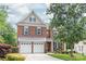Charming brick two-story home with a manicured front yard and a two car garage at 8115 Wilburn Ct, Charlotte, NC 28277