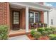 Inviting front porch with rocking chairs, white columns and a well landscaped garden at 8115 Wilburn Ct, Charlotte, NC 28277