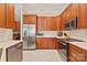 Well-equipped kitchen with stainless steel appliances and wooden cabinetry for ample storage at 8115 Wilburn Ct, Charlotte, NC 28277
