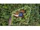 Home's aerial view surrounded by trees, displaying its property lines, nestled in a lush forest, offering privacy and natural beauty at 813 Montreat Dr, Dallas, NC 28034