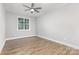 Bedroom with wood floor, ceiling fan, and window providing natural light at 813 Montreat Dr, Dallas, NC 28034