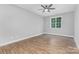 Spacious bedroom featuring wood floors, ceiling fan, and large window at 813 Montreat Dr, Dallas, NC 28034