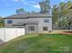 Exterior of home featuring a wooden deck, fenced-in yard with lush green grass and privacy at 8315 Adrian Ct, Charlotte, NC 28270