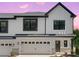 Charming two-story home featuring a two-car garage, craftsman front door and pristine white siding with stone accents at 8315 Adrian Ct, Charlotte, NC 28270