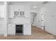 Elegant bar area with a wine fridge, white cabinetry, quartz countertops, and stylish decor near staircase at 8315 Adrian Ct, Charlotte, NC 28270