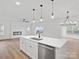 Modern open-concept kitchen featuring a large island, stainless steel appliances, and seamless flow to the living area at 8315 Adrian Ct, Charlotte, NC 28270