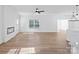 Spacious living room featuring hardwood floors, a modern ceiling fan, and fireplace at 8315 Adrian Ct, Charlotte, NC 28270