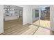Living room showcasing open layout to the kitchen, hardwood floors and access to deck at 8315 Adrian Ct, Charlotte, NC 28270
