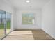 Well-lit sunroom featuring hardwood floors, sliding glass door, and neutral walls at 8315 Adrian Ct, Charlotte, NC 28270
