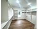 Walk-in closet showcasing built-in shelving and hardwood floors at 8315 Adrian Ct, Charlotte, NC 28270