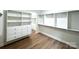 Spacious walk-in closet with custom shelving, drawers, and modern wood flooring, providing ample storage at 8315 Adrian Ct, Charlotte, NC 28270