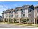 Well-maintained townhomes with varied siding colors and manicured lawns, adding curb appeal at 8316 Waxhaw Hwy, Waxhaw, NC 28173