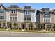 Charming townhome showcasing a well-manicured lawn, brick accents, and neutral siding under a bright sky at 8316 Waxhaw Hwy, Waxhaw, NC 28173