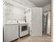 Convenient laundry room with washer, dryer, shelving and closet at 8316 Waxhaw Hwy, Waxhaw, NC 28173