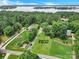 Aerial shot showcasing a home with a long driveway surrounded by lush green lawns and mature trees at 832 Kemp Rd, Mooresville, NC 28117