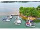 Aerial view of a serene lake, highlighting the marina with multiple docks and boats at 832 Kemp Rd, Mooresville, NC 28117