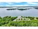 Aerial view of a lake with a marina, lush greenery, and a parking area amidst a scenic landscape at 832 Kemp Rd, Mooresville, NC 28117