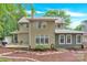 View of the landscaped backyard, deck, grill, patio area, and mature trees at 832 Kemp Rd, Mooresville, NC 28117