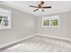 Neutral bedroom featuring plush carpet, ceiling fan and natural light from the double windows at 832 Kemp Rd, Mooresville, NC 28117