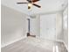 This neutral bedroom has plush carpet, crown molding, ceiling fan and double door closet at 832 Kemp Rd, Mooresville, NC 28117