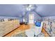 Cozy bonus room featuring unique architecture, hardwood floors, and comfortable seating at 832 Kemp Rd, Mooresville, NC 28117
