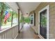 Inviting covered porch featuring a bay window, offering a glimpse of the serene outdoor surroundings at 832 Kemp Rd, Mooresville, NC 28117