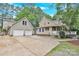 Exterior view of home featuring a two-car garage, well-manicured lawn and covered porch at 832 Kemp Rd, Mooresville, NC 28117