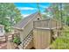 The outside of the building has stone landscaping, and a small deck that can be accessed by stairs at 832 Kemp Rd, Mooresville, NC 28117