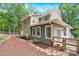 Landscaped backyard featuring patio area, a wooden fence, mature trees, and patio area with grill at 832 Kemp Rd, Mooresville, NC 28117