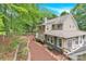 Landscaped backyard featuring a wooden fence, established trees, patio area, and a deck with grill at 832 Kemp Rd, Mooresville, NC 28117