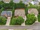 Aerial view of a brick home on a manicured lawn with mature trees and green landscaping in a residential area at 8921 Whittingham Dr, Waxhaw, NC 28173